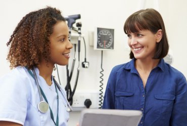 female healthcare worker talking to woman