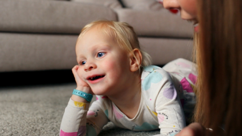 sienna lying on her front with her chin resting on her hand against the floor