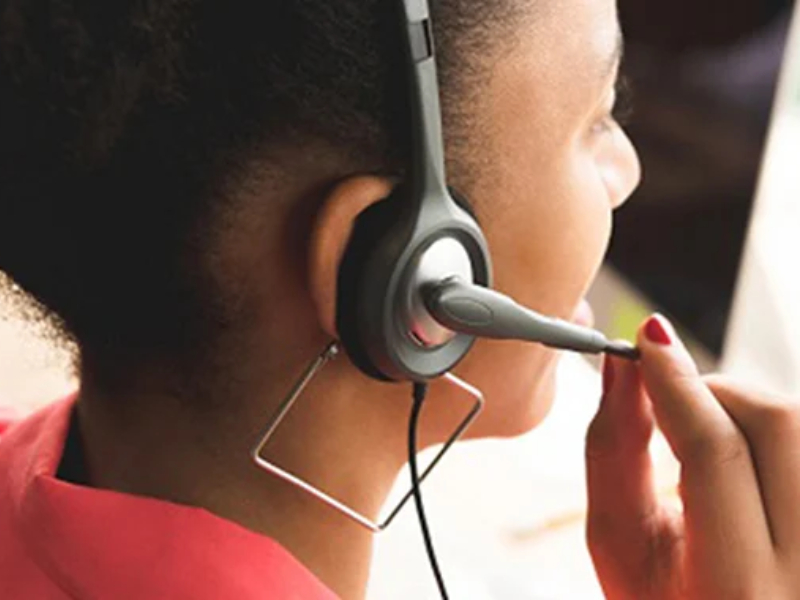 A woman using a headset to talk to someone