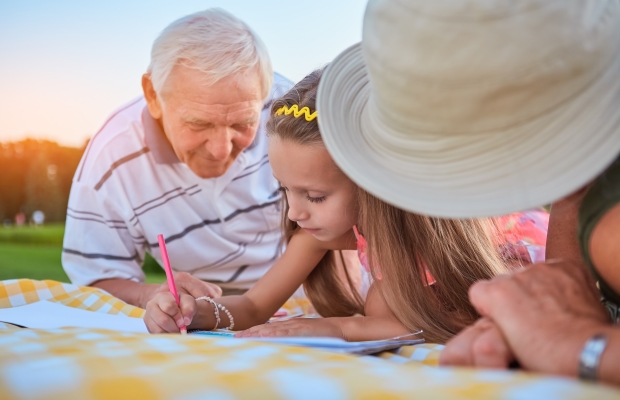 Grandparents sketching with granddaughter