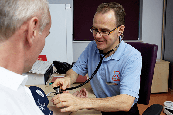 A healthcare professional checks blood pressure numbers