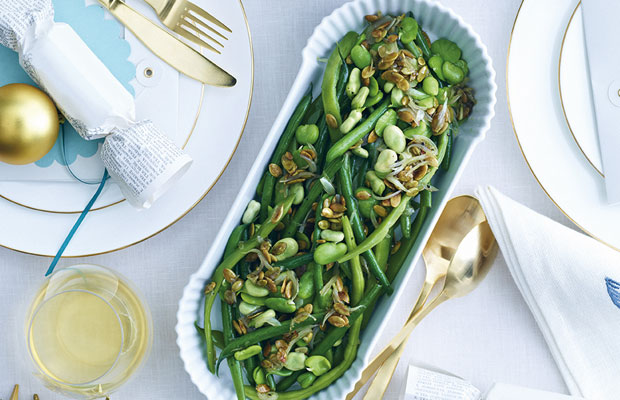 A dish of green vegetables on a table 