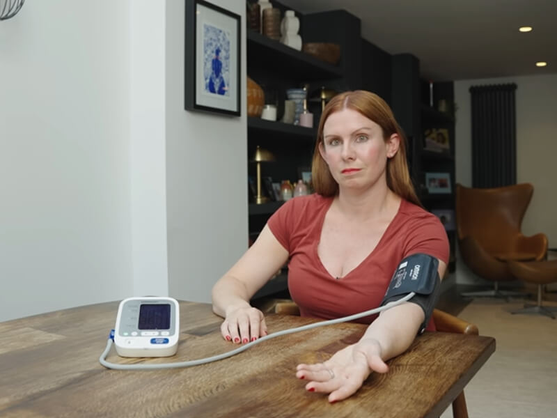Senior Cardiac Nurse demonstrates how to check your blood pressure with a monitor