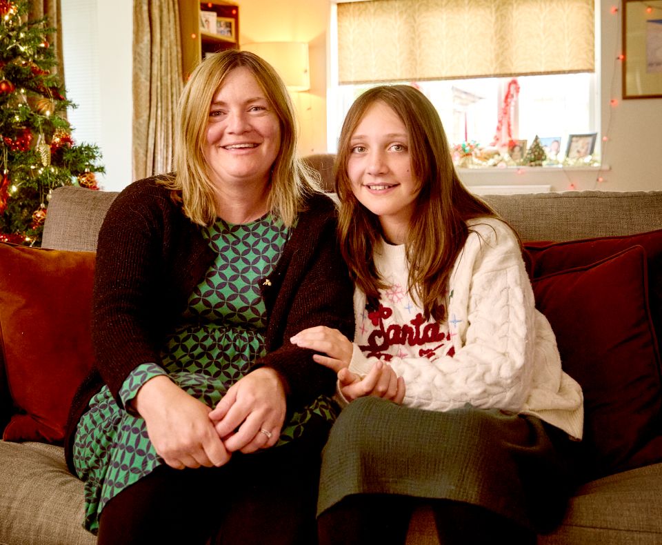 Bea and mum sitting on a sofa
