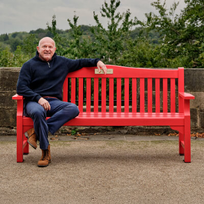 Dean, sitting on a bench outdoors.