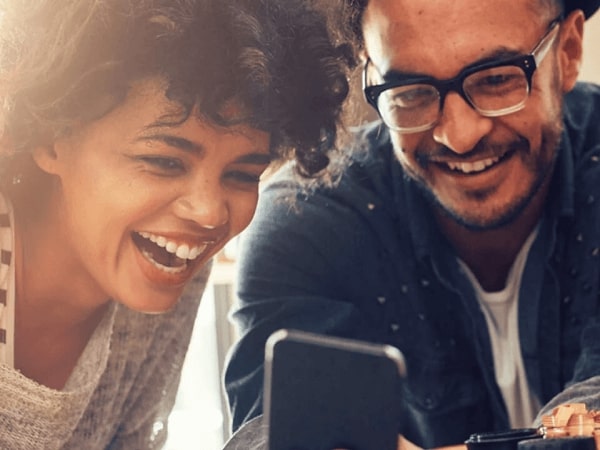 Two people check the results of the BHF raffle on a phone