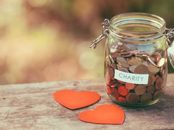 A jar of coins labelled with the word "charity"