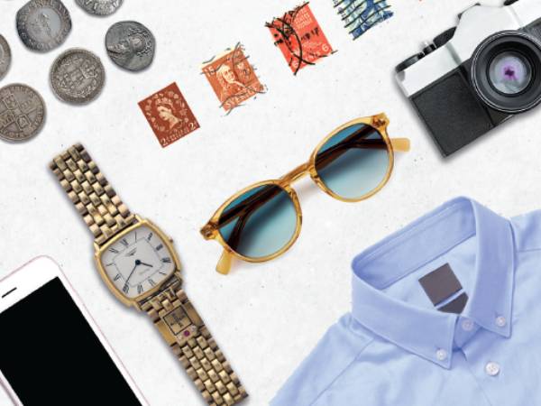 A collection of items ready to post, including sunglasses and a phone.