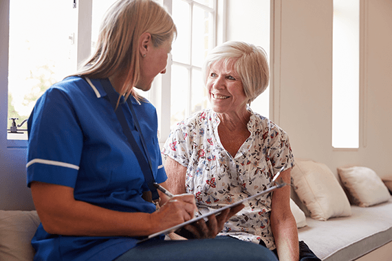 A nurse visits a patient in their home