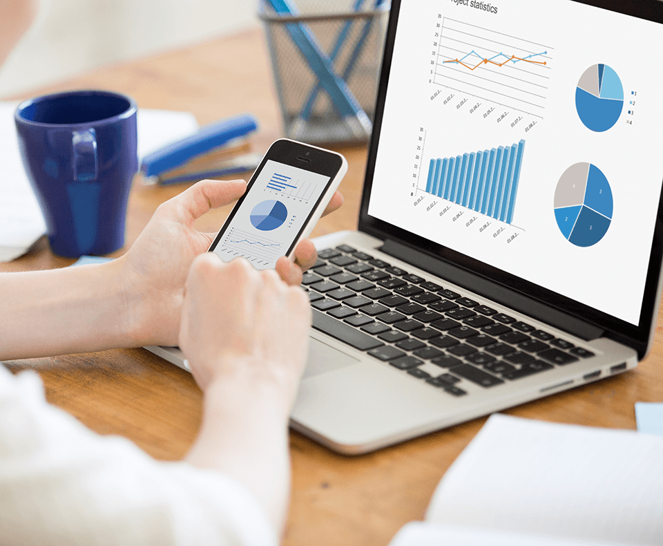 looking at data on phone and laptop