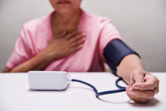 Concerned woman taking her blood pressure
