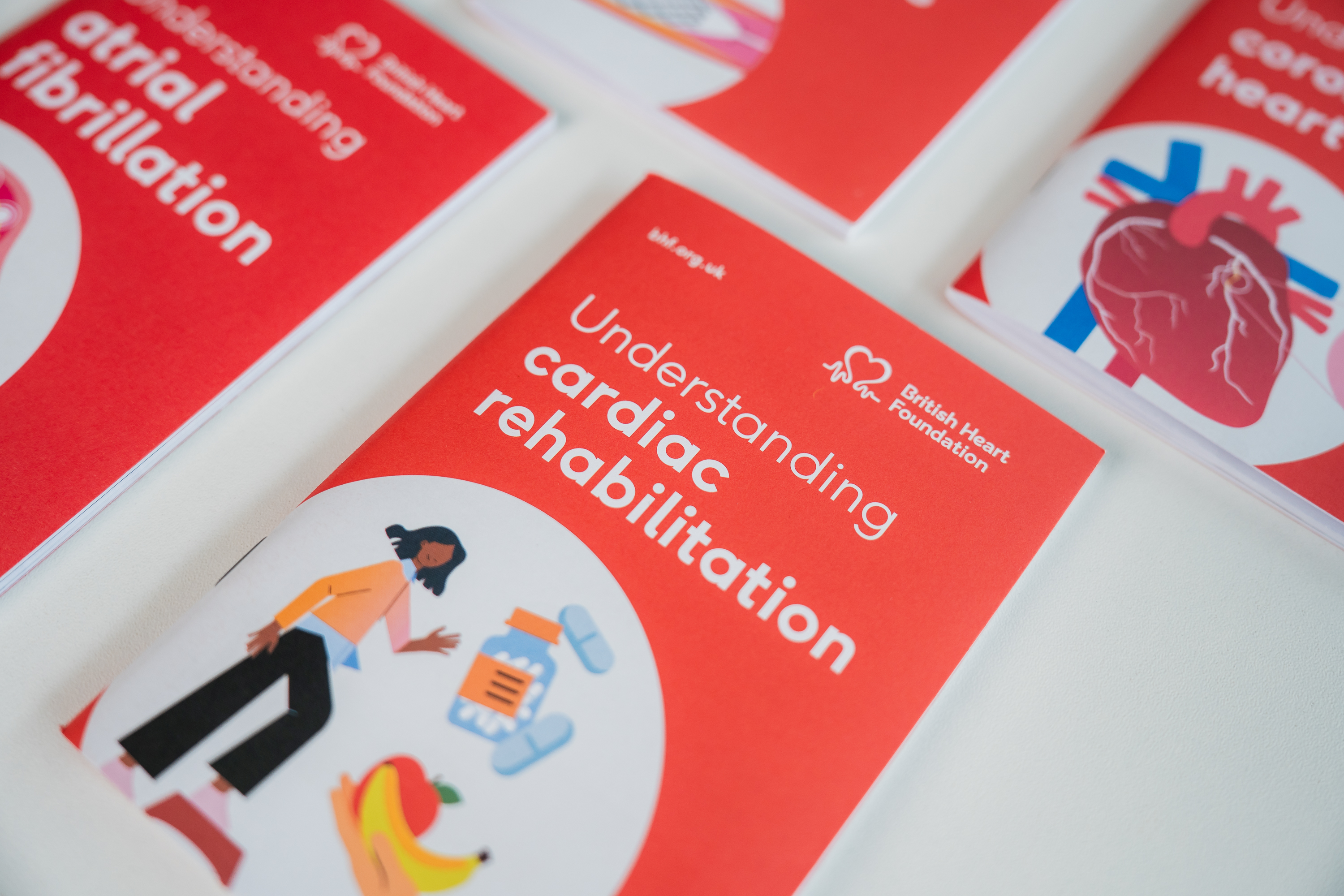 a row of BHF free printed information booklets sitting on a white table