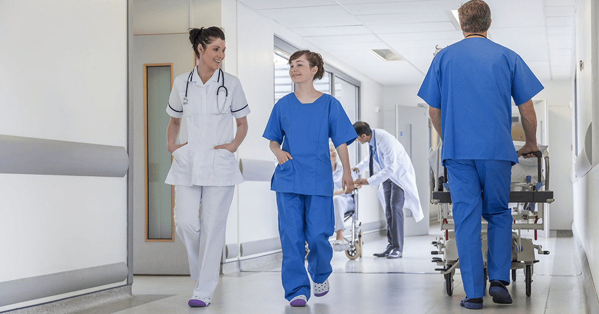 Healthcare professionals walking in a corridor