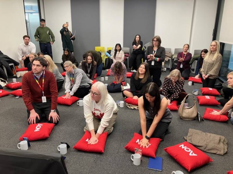 Employees taking part in an office CPR training session