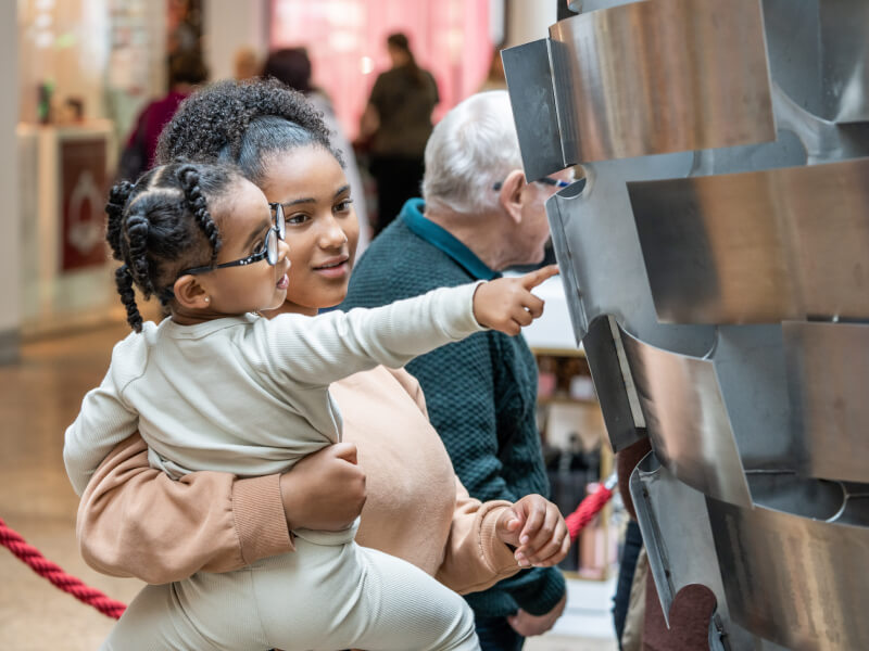 A mother and child are looking at the Heart of Steel