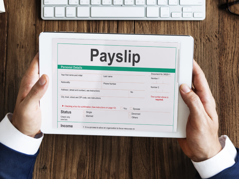 A person looking at a payslip on a tablet device.