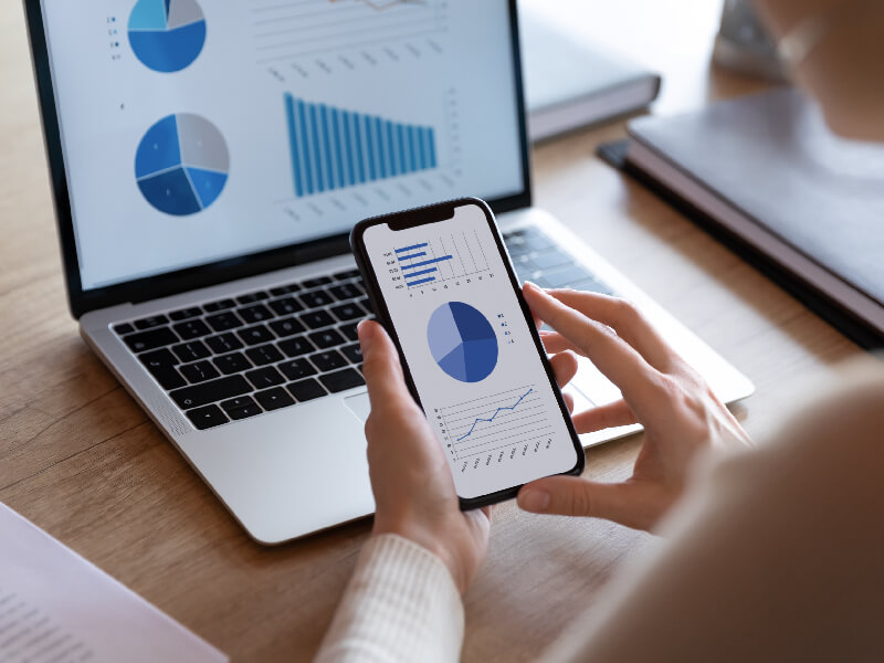 A person looking at a graph on a phone.