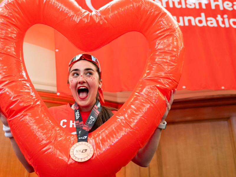 BHF supporter holding a red inflatable heart 