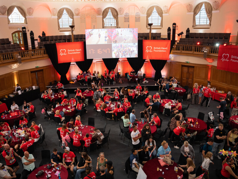 BHF supporters wearing red while seated at tables inside a banquet hall