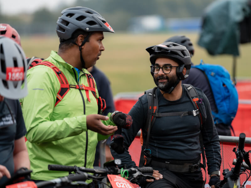 Two riders having a conversation at the start line