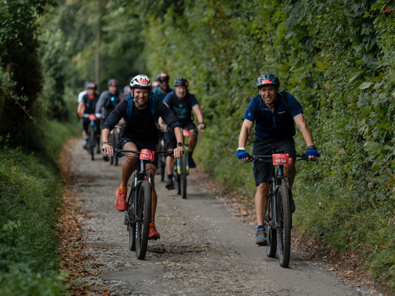 A group of bike riders cycling down a path