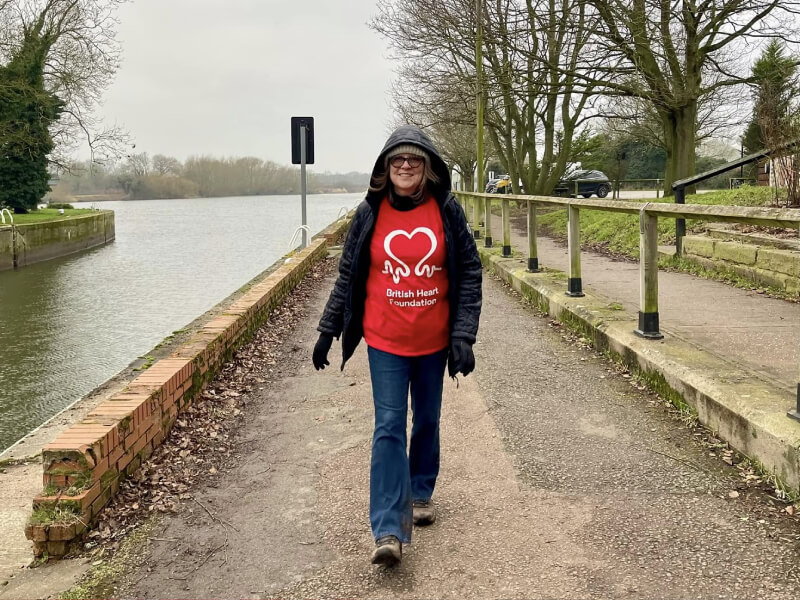 A photograph of fundraiser Ruth, walking by a river.