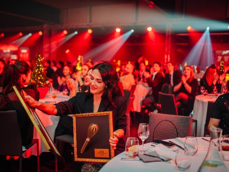 Crowd of people at tables at an evening charity ball