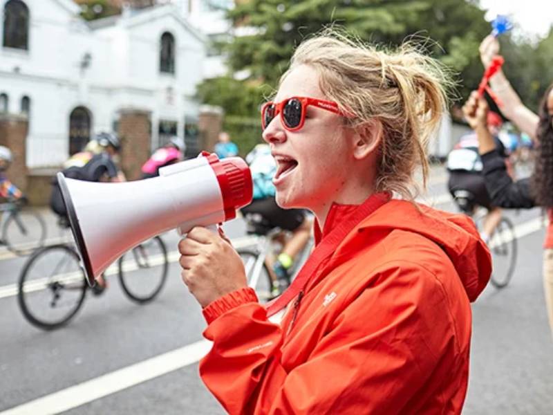 A BHF supporter speaks into a megaphone at an event