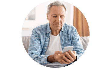 Seated man looking at mobile phone