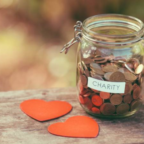 A glass jar filled with pennies and silver coins