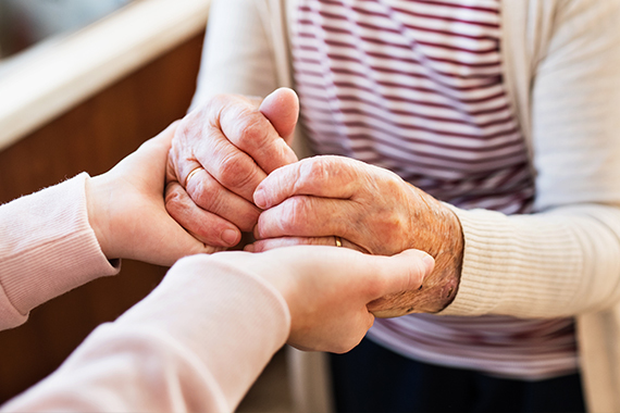 Hands holding each other 570x380