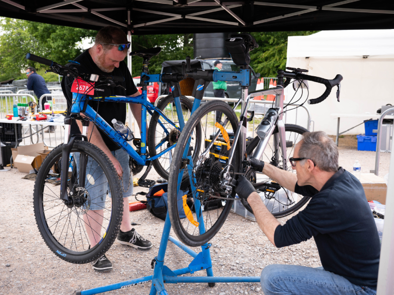 Two mechanics fixing bikes together