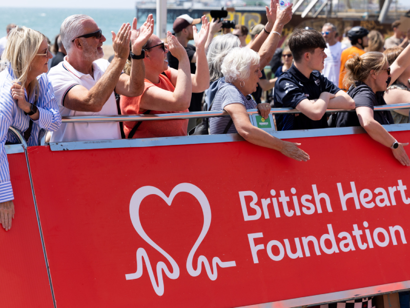 Spectators applauding bike riders at the London to Brighton bike ride