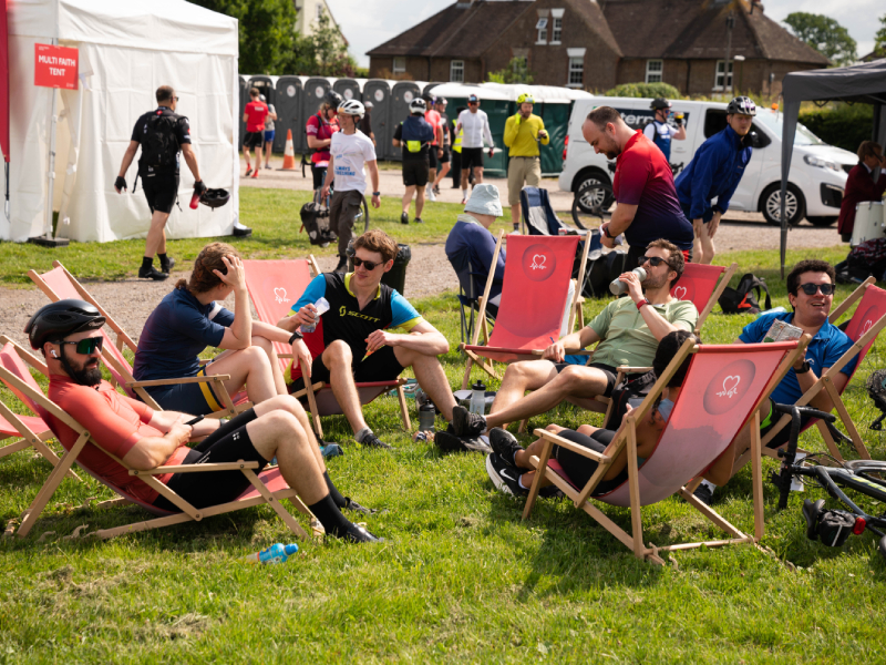 A group of London to Brighton riders sitting on the grass