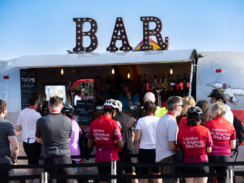 London to Brighton riders queuing at a bar