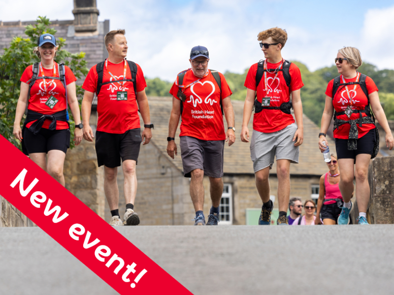 A group of fundraisers in red BHF t-shirts are walking to raise money.