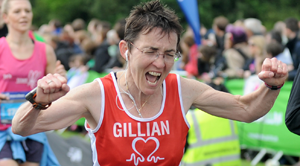 A woman celebrating crossing the finish line