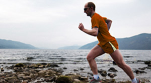 BHF volunteer running by the beach