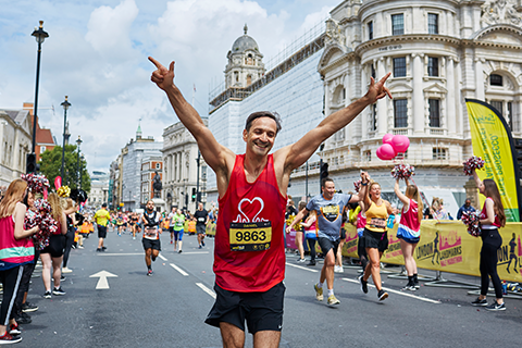 Man crossing the finish line at London Landmarks Half Marathon