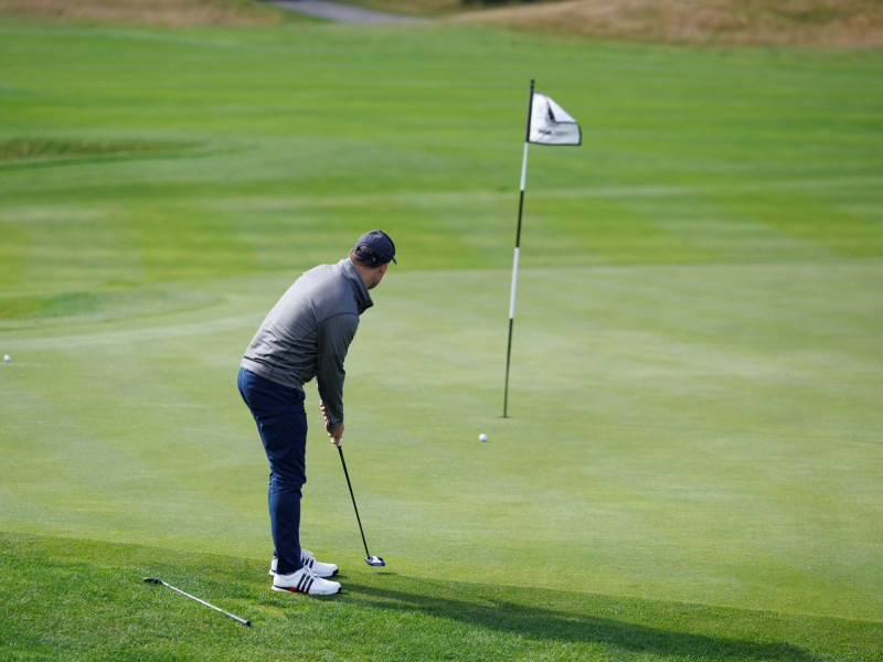 Andrew Chapman putting at a golf course