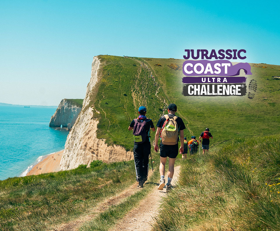 Image of trekkers taking on Jurassic Coast challenge along hills 