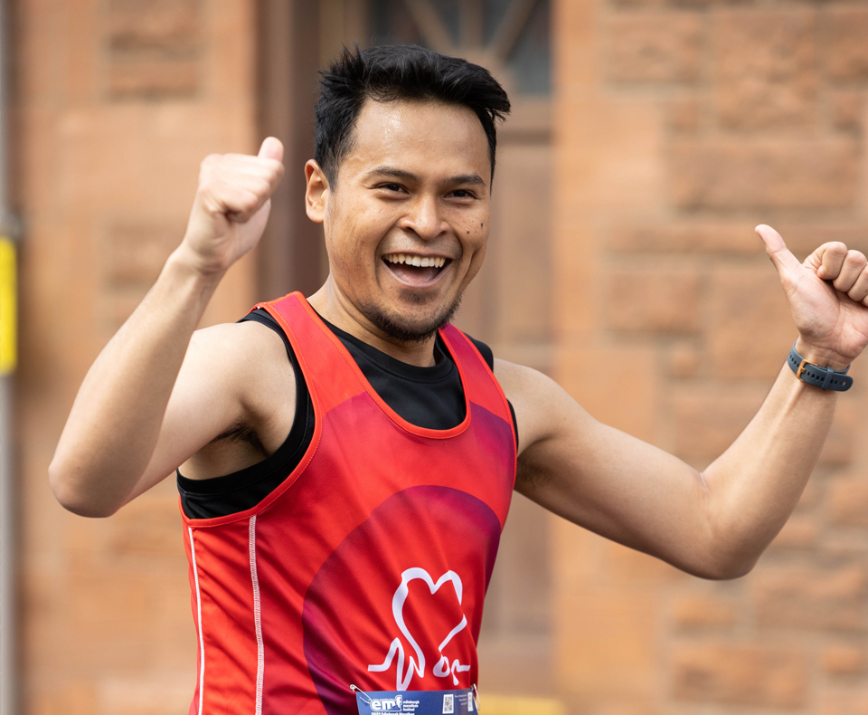 Person running with hands in the air, celebrating