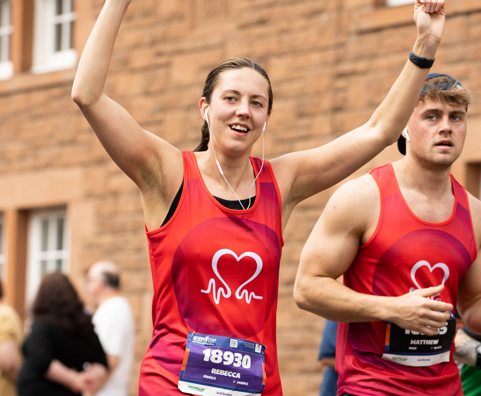 Person running in a race with arms in the air