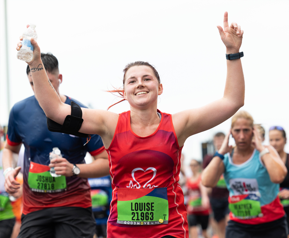 Person running and raising their hands in the air