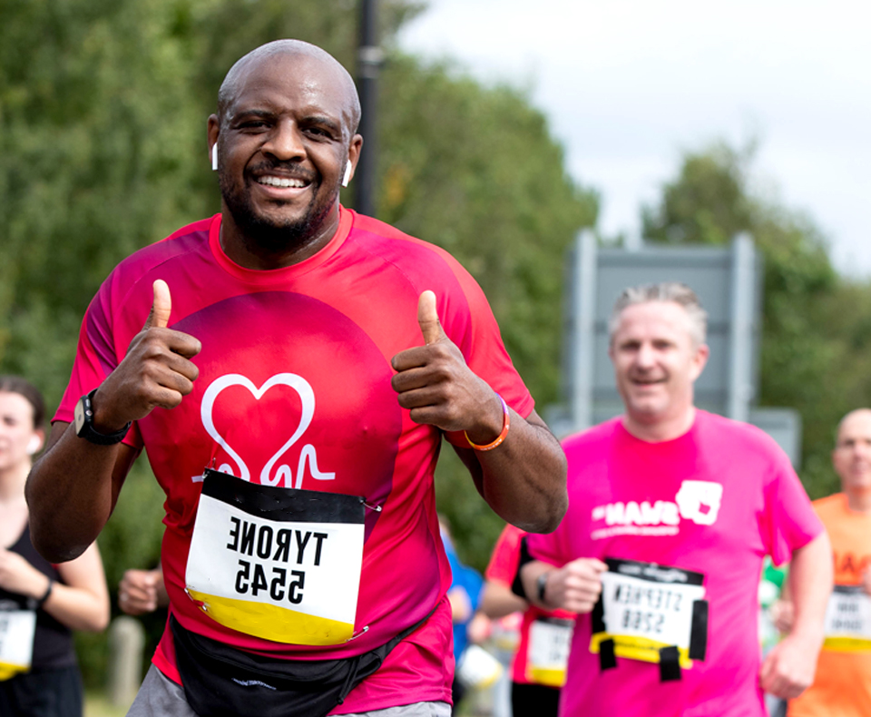 Runner smiling at camera and putting their thumbs up