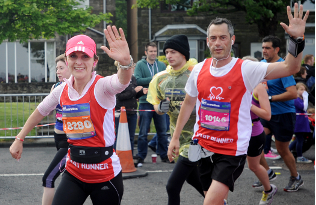 A couple give a smile and a wave on a BHF run.