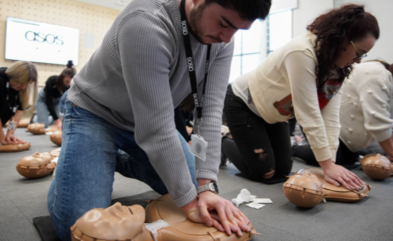 Asos employees performing CPR as part of their training session from the Health at Work team