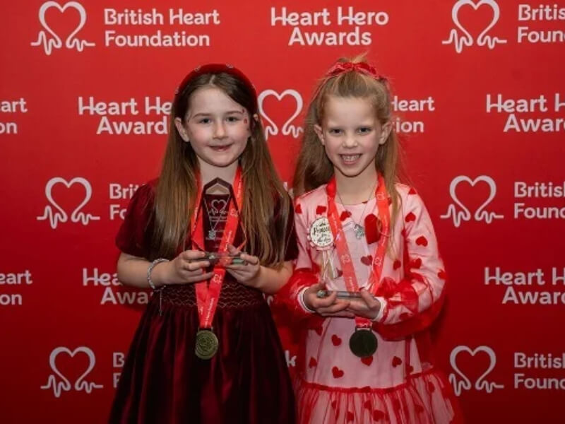Two children with Young Heart Hero Awards medals