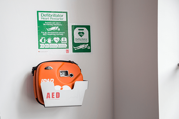 Defibrillator in a case on a wall