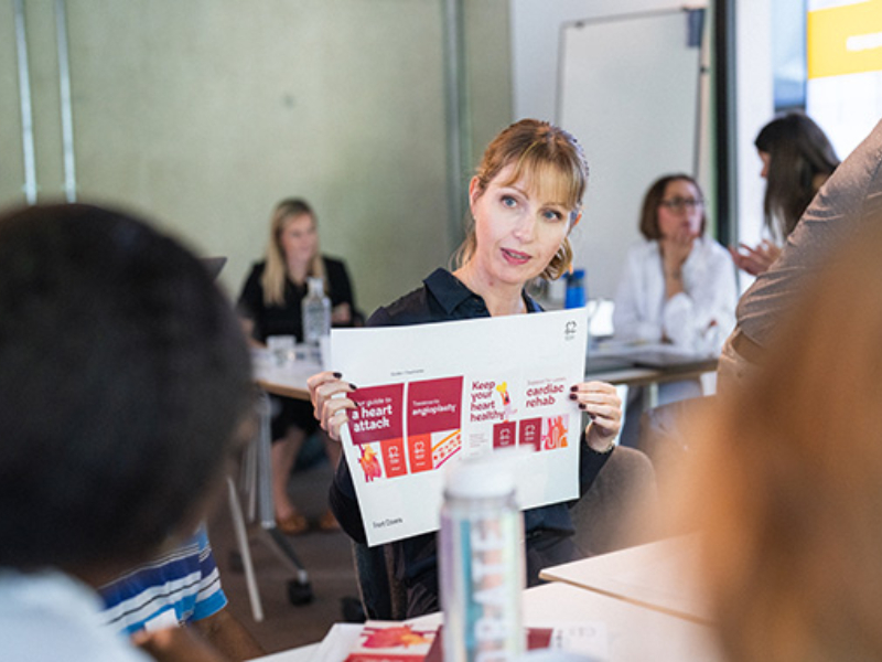 A woman presenting a document to a group of people